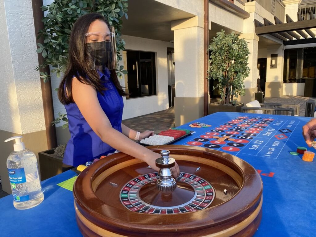 Casino craps table with model dealer at a themed party