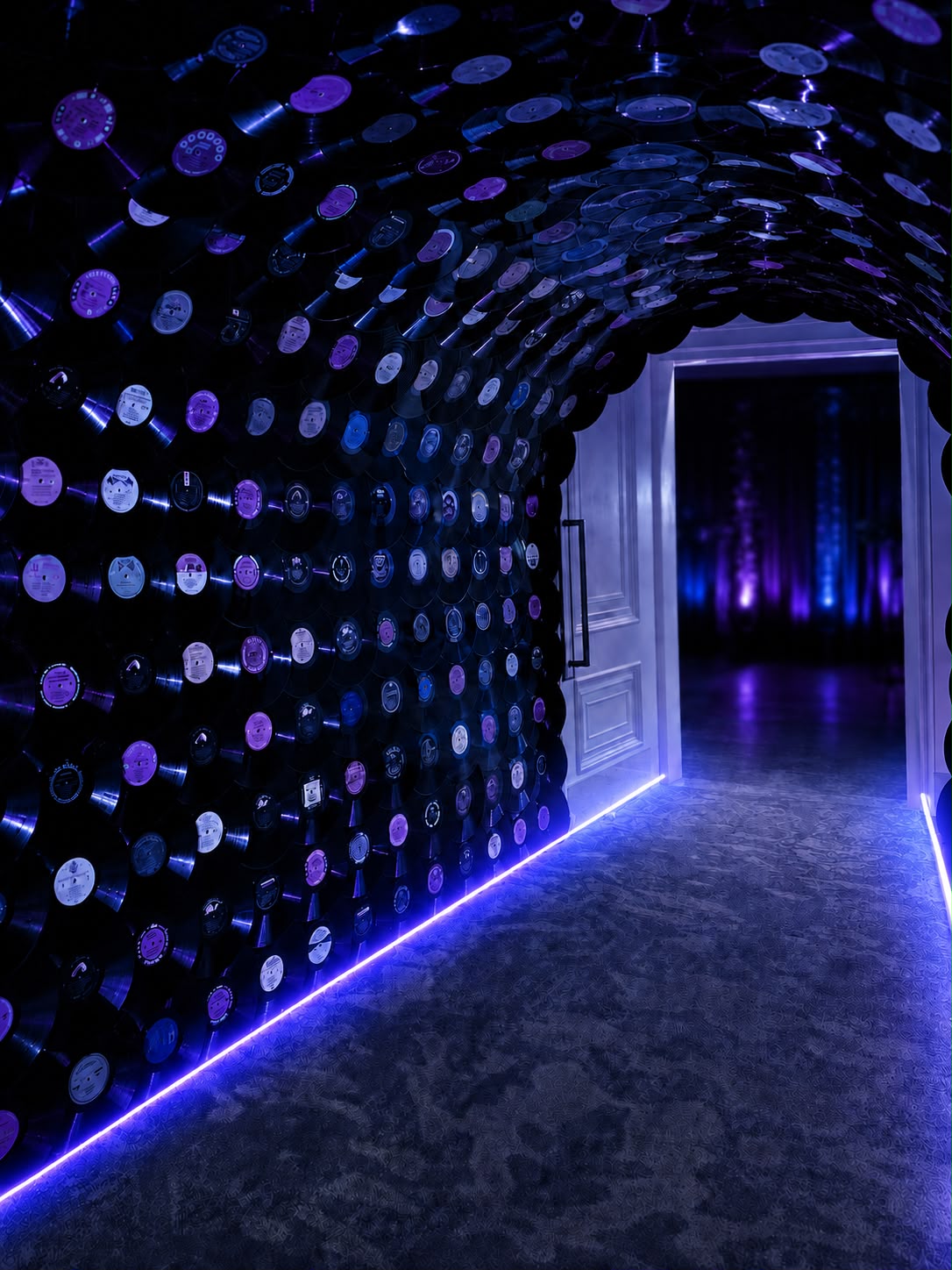 Immersive entry tunnel built from hundreds of vinyl records with LED accents