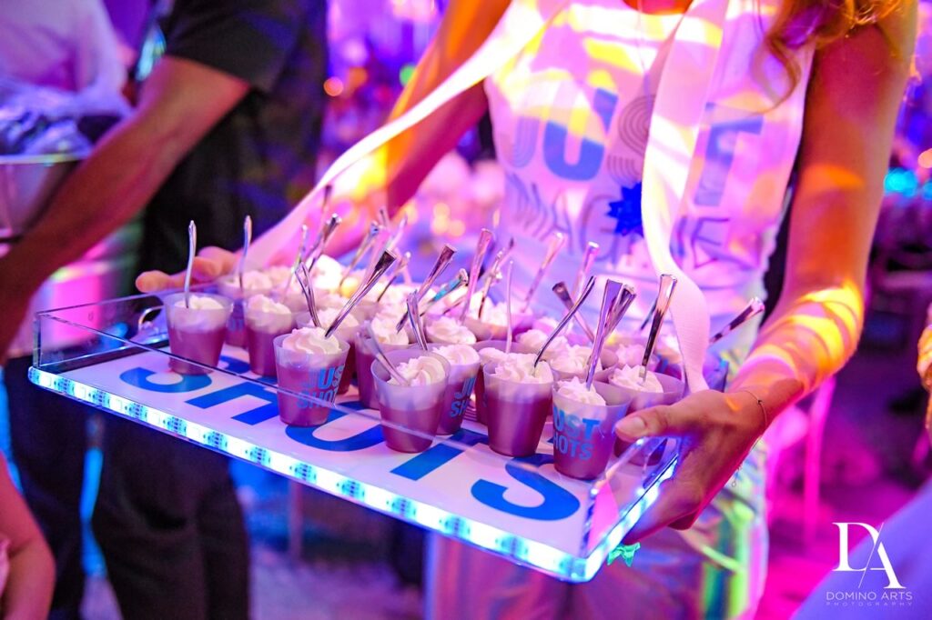 Model servers passing champagne during cocktail hour