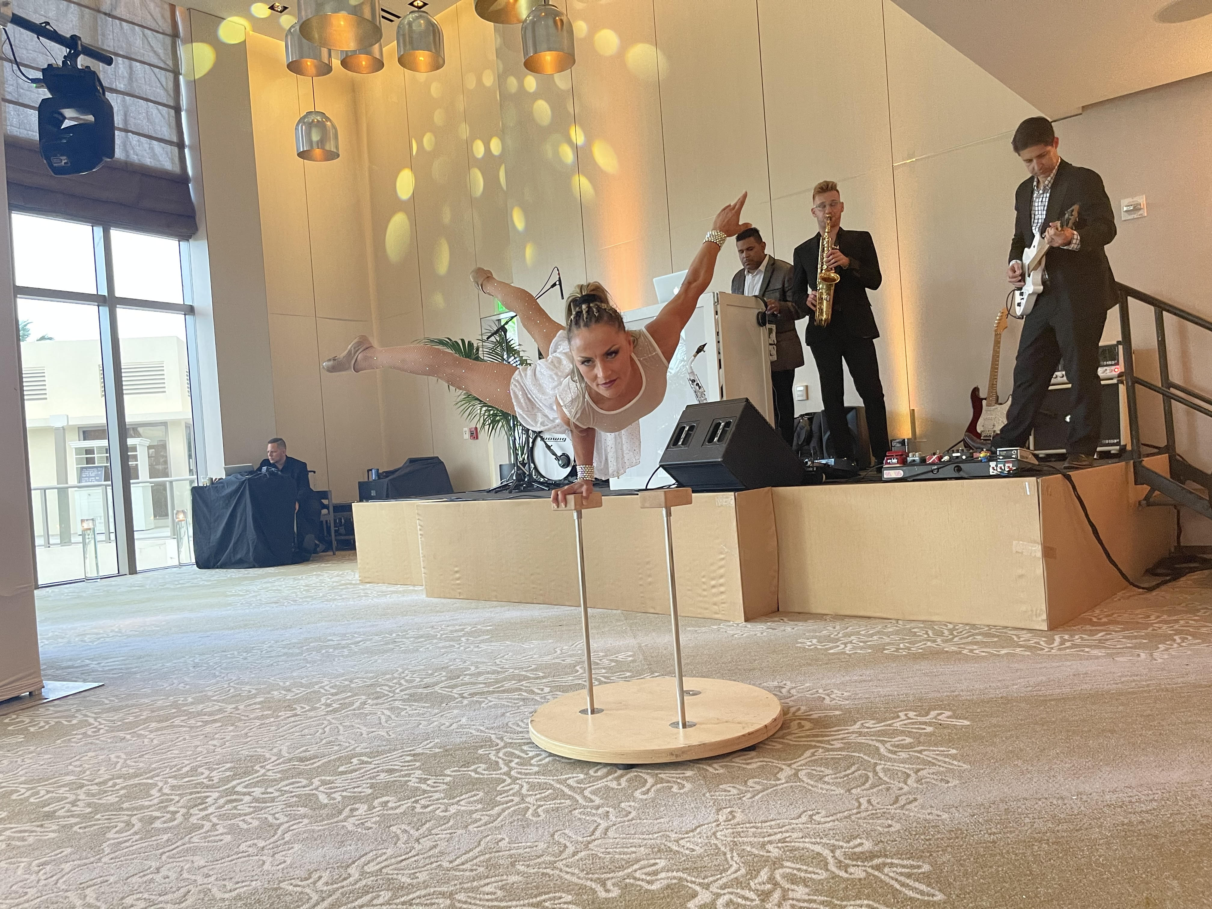 Breakdancer performing alongside a live band at a ballroom event