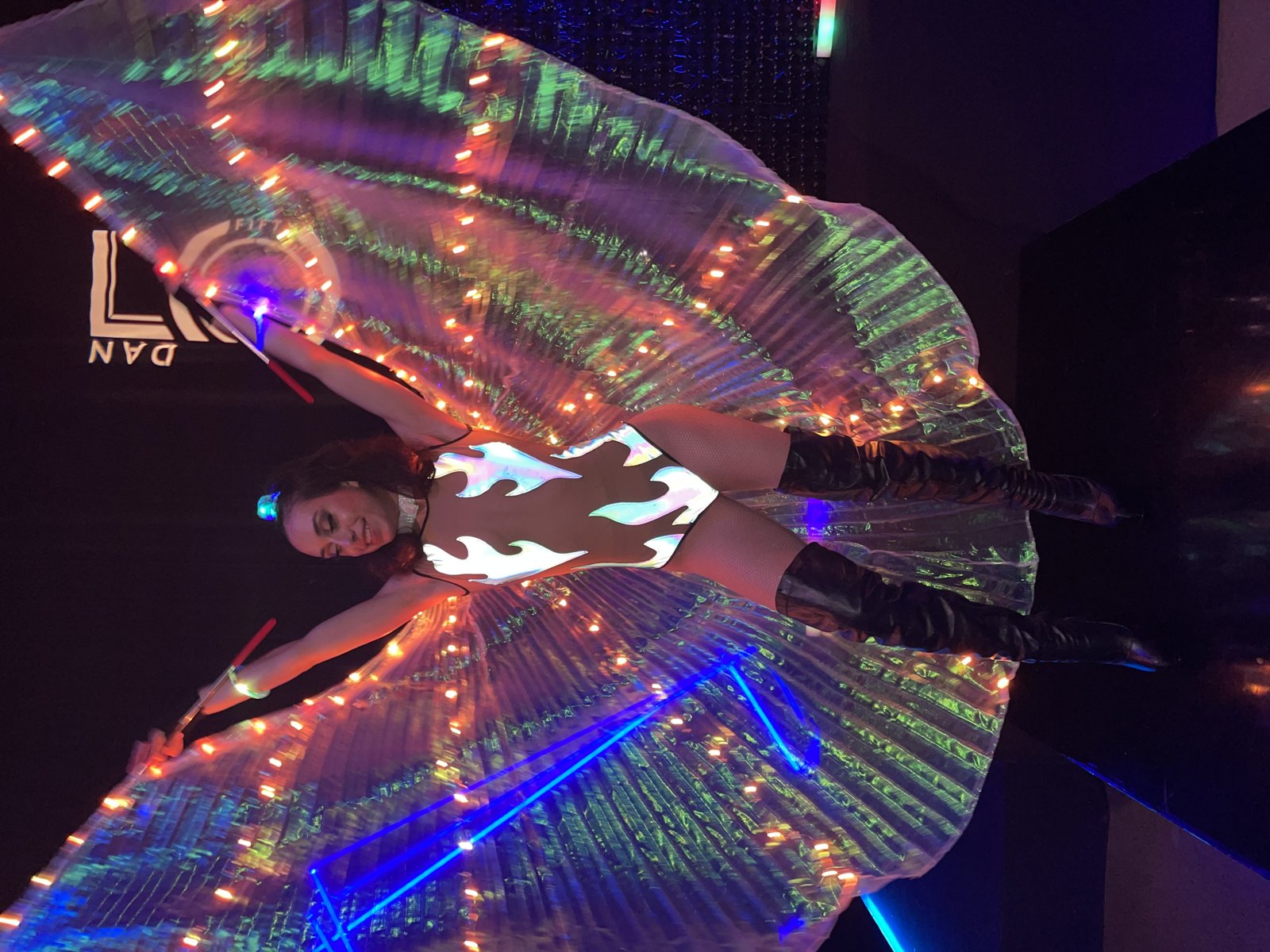 Performer in illuminated LED wing costume